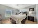 This bedroom features wood-look tile, a ceiling fan and a large window for natural light at 1310 Grand Blvd # 202, Sarasota, FL 34232