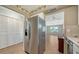 Bright kitchen featuring white cabinets, stainless steel appliances, and a view into the living room at 1310 Grand Blvd # 202, Sarasota, FL 34232