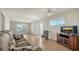 Inviting living room with wood-look tile flooring, neutral paint, and an abundance of natural light at 1310 Grand Blvd # 202, Sarasota, FL 34232