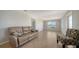 Spacious living room featuring wood-look floors, light walls, and lots of windows with natural light at 1310 Grand Blvd # 202, Sarasota, FL 34232