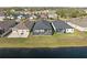 Aerial view of homes with screened-in back porches backing up to a large lake with mature landscaping at 14238 59Th E Cir, Bradenton, FL 34211