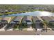 A picturesque view of the homes next to a large lake in the neighborhood with plenty of beautiful greenery at 14238 59Th E Cir, Bradenton, FL 34211
