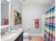 Well-lit bathroom with a shower and tub combination, stylish accents, and a coordinated color scheme for a fresh look at 14238 59Th E Cir, Bradenton, FL 34211