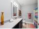Bright bathroom features a modern vanity, framed mirror, and stylish decor with a shower/tub combo at 14238 59Th E Cir, Bradenton, FL 34211