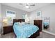 Cozy bedroom with large bed, side tables, ceiling fan and natural light at 14238 59Th E Cir, Bradenton, FL 34211