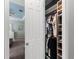 Walk-in closet with neatly organized clothing and shoe racks at 14238 59Th E Cir, Bradenton, FL 34211