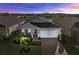 Charming single-story home with a well-manicured lawn, brick driveway, and attached two-car garage at 14238 59Th E Cir, Bradenton, FL 34211