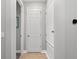 Hallway view featuring white doors and neutral wall paint at 14238 59Th E Cir, Bradenton, FL 34211