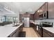 Modern kitchen with stainless steel appliances, dark cabinets, and a spacious island at 14238 59Th E Cir, Bradenton, FL 34211