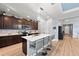 Bright kitchen with an island, seating, and a view of a decorated dining room at 14238 59Th E Cir, Bradenton, FL 34211