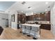 Well-lit kitchen featuring a large island with gray barstools and stainless steel appliances at 14238 59Th E Cir, Bradenton, FL 34211