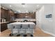 Spacious kitchen with stainless steel appliances, a large island, and dark wood cabinets at 14238 59Th E Cir, Bradenton, FL 34211