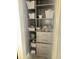Organized linen closet with shelves, drawers, and woven storage baskets at 14238 59Th E Cir, Bradenton, FL 34211