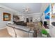 Spacious living room with comfortable seating, built-in entertainment center, and seamless flow to the kitchen at 14238 59Th E Cir, Bradenton, FL 34211