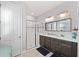 The main bathroom featuring double sinks, walk-in shower, and natural lighting at 14238 59Th E Cir, Bradenton, FL 34211