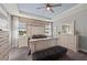 Serene main bedroom featuring a decorative wall, tray ceiling, and stylish furniture at 14238 59Th E Cir, Bradenton, FL 34211