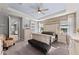 Bright main bedroom featuring wood accent wall, bench seating, and an ensuite bath at 14238 59Th E Cir, Bradenton, FL 34211