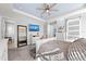 Bright main bedroom with a large mirror, TV, and ensuite bath entrance at 14238 59Th E Cir, Bradenton, FL 34211
