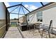Relaxing screened-in patio with hot tub, outdoor dining, and view of the pond, perfect for unwinding at 14238 59Th E Cir, Bradenton, FL 34211