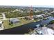 Aerial view showcasing the home, pool, dock, and waterfront location at 15484 Alsask Cir, Port Charlotte, FL 33981