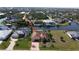 Scenic aerial view of waterfront home with tile roof and well-manicured lawn at 15484 Alsask Cir, Port Charlotte, FL 33981