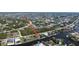 Aerial view of the home, waterfront location, and surrounding community at 15484 Alsask Cir, Port Charlotte, FL 33981