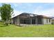 Spacious backyard featuring an in-ground pool and screened lanai for outdoor enjoyment at 15484 Alsask Cir, Port Charlotte, FL 33981