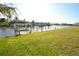 Expansive backyard leading to a private dock on the waterfront at 15484 Alsask Cir, Port Charlotte, FL 33981