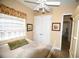 Cozy bedroom featuring neutral decor, white furniture, a ceiling fan and a patterned bedspread at 15484 Alsask Cir, Port Charlotte, FL 33981