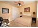 Comfortable bedroom with a ceiling fan, lamp lighting and a closet perfect for guests at 15484 Alsask Cir, Port Charlotte, FL 33981
