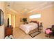 The bedroom features neutral tones, a tray ceiling and a ceiling fan making it the perfect retreat at 15484 Alsask Cir, Port Charlotte, FL 33981