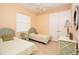 Cozy bedroom with twin beds, ideal for children or guests, featuring soft colors and ample closet space at 15484 Alsask Cir, Port Charlotte, FL 33981