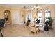 Elegant dining room with chandelier, arched windows, and neutral colors at 15484 Alsask Cir, Port Charlotte, FL 33981