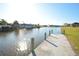 Scenic view of the canal from a dock with bright sunshine at 15484 Alsask Cir, Port Charlotte, FL 33981