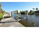 View of a wooden dock with a boat lift at 15484 Alsask Cir, Port Charlotte, FL 33981