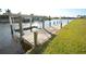 Wooden dock on the water with a boat lift at 15484 Alsask Cir, Port Charlotte, FL 33981