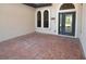 Welcoming front porch features decorative concrete and a stylish front door with sidelights at 15484 Alsask Cir, Port Charlotte, FL 33981