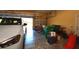 Spacious two car garage with a car parked inside, storage bins, and bicycles at 15484 Alsask Cir, Port Charlotte, FL 33981