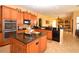Open kitchen featuring granite countertops, stainless steel appliances, and ample storage at 15484 Alsask Cir, Port Charlotte, FL 33981