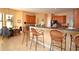 Enjoy casual dining at the breakfast bar, connecting the kitchen to the dining area, creating an open and airy space at 15484 Alsask Cir, Port Charlotte, FL 33981