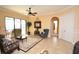 Elegant living room featuring tile floors, neutral colors, and sliding glass doors at 15484 Alsask Cir, Port Charlotte, FL 33981