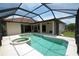 Screened in pool and spa with a tranquil view of the backyard at 15484 Alsask Cir, Port Charlotte, FL 33981