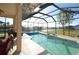 Screened swimming pool and spa with scenic waterfront views at 15484 Alsask Cir, Port Charlotte, FL 33981