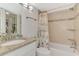 Bathroom featuring a granite vanity, decorative mirror and tiled shower at 1618 Stickney Point Rd # 101, Sarasota, FL 34231