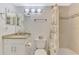 Bathroom featuring a granite vanity, decorative mirror and tiled shower at 1618 Stickney Point Rd # 101, Sarasota, FL 34231