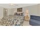 Comfortable bedroom featuring a floral bedspread, side tables and a chair at 1618 Stickney Point Rd # 101, Sarasota, FL 34231