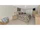 Cozy bedroom with a ceiling fan, decorative pillows and tiled floor at 1618 Stickney Point Rd # 101, Sarasota, FL 34231