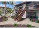 The exterior of this home features well-maintained landscaping, a staircase, and proximity to the water at 1618 Stickney Point Rd # 101, Sarasota, FL 34231