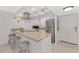 Updated kitchen features modern stainless steel appliances, light granite countertops, and barstool seating for casual dining at 1618 Stickney Point Rd # 101, Sarasota, FL 34231