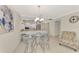 Bright kitchen, stainless steel appliances, granite countertops, and a glass table with seating for four create a cozy dining space at 1618 Stickney Point Rd # 101, Sarasota, FL 34231